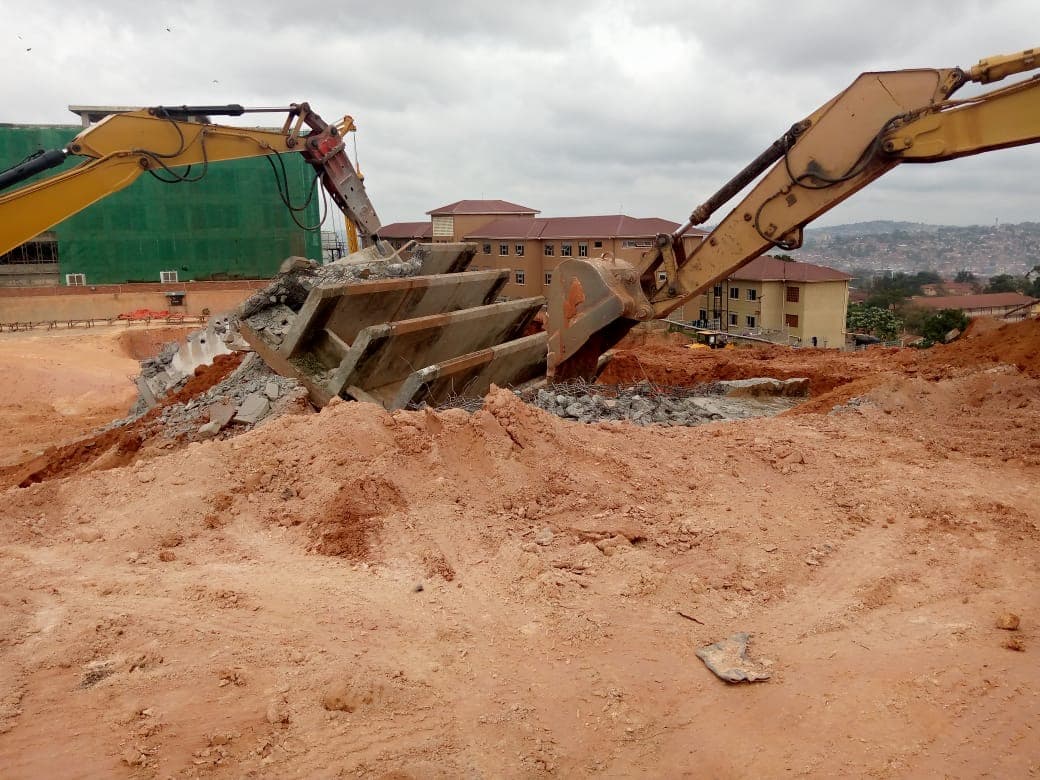 Excavators carrying out controlled concrete demolition