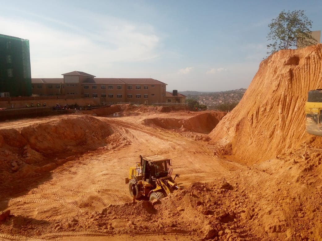 Loader shaping an excavated construction platform