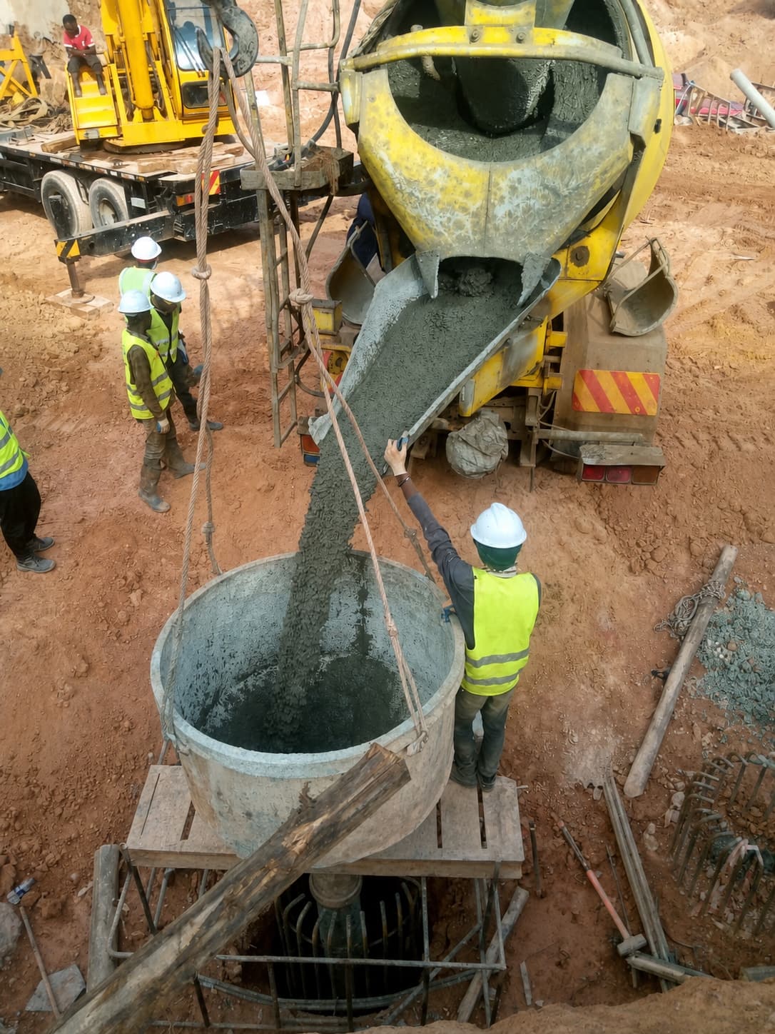 Concrete being transferred into a prepared pile opening