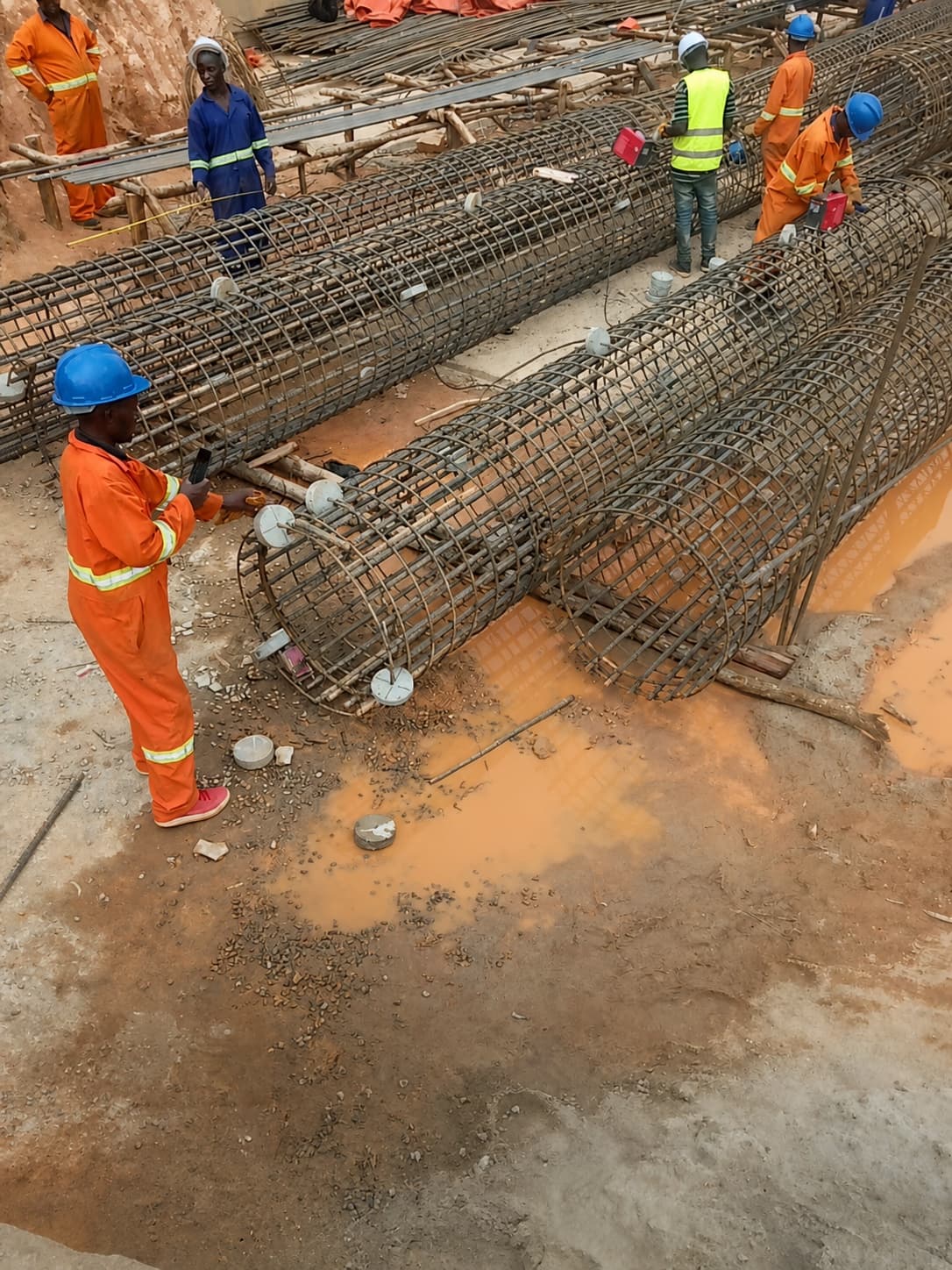 Construction teams assembling reinforcement cages
